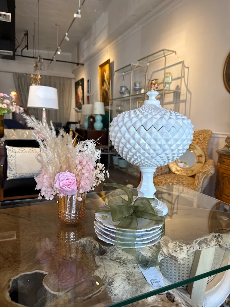 Driftwood-base glass table with curated decor at Accentiques