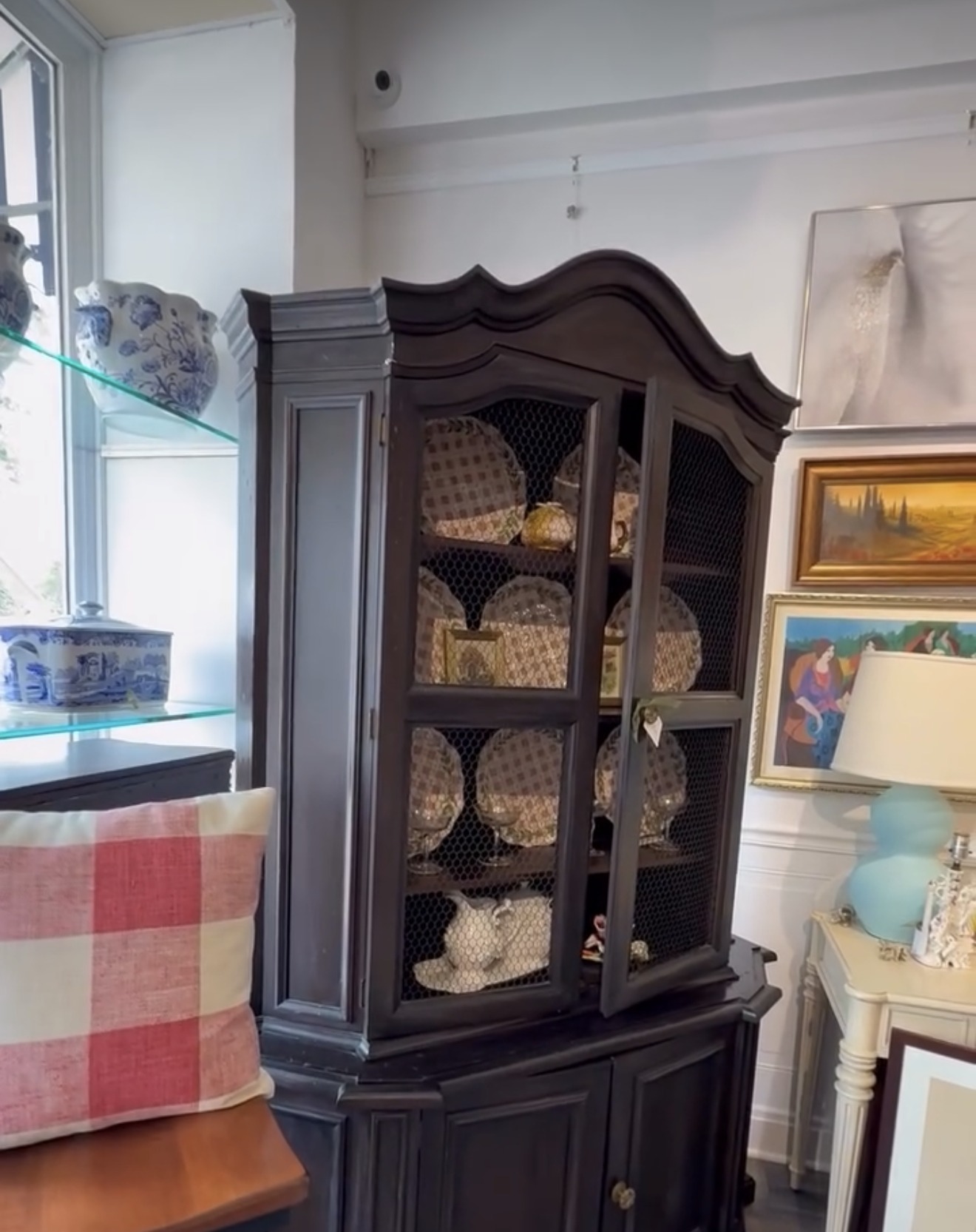 Black painted china cabinet with mesh doors