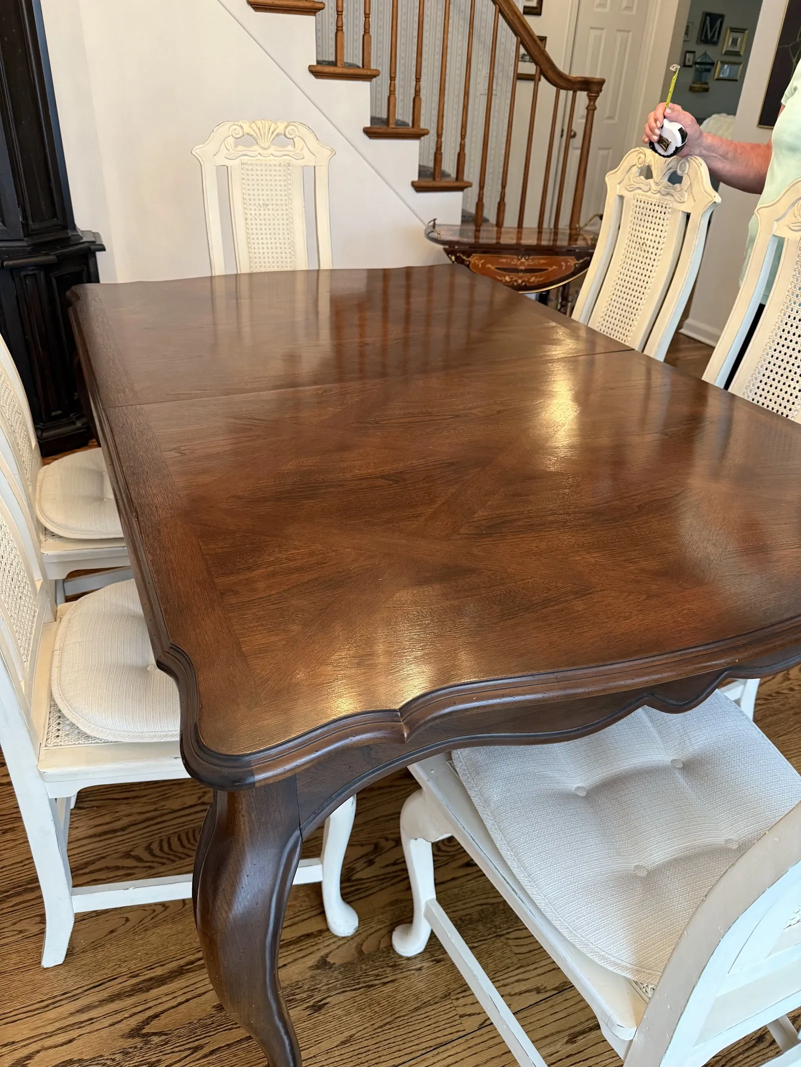 Wood dining table with upholstered white chairs