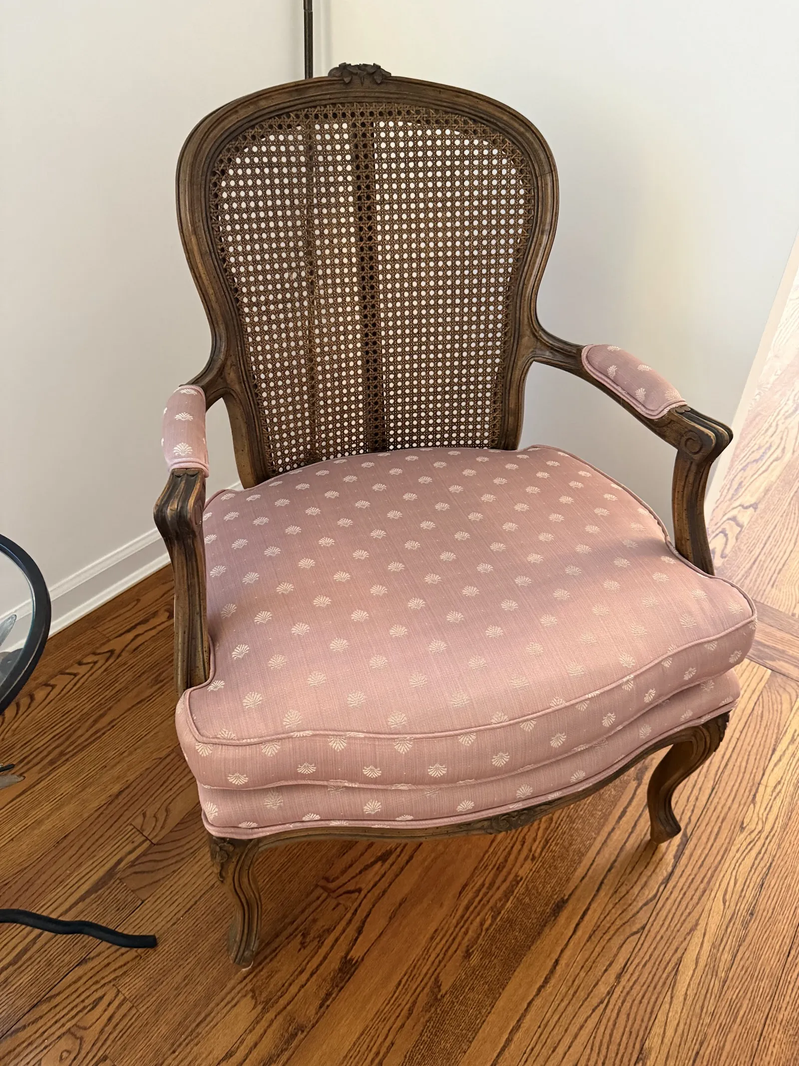 Carved wood armchair with pink polka-dot upholstery