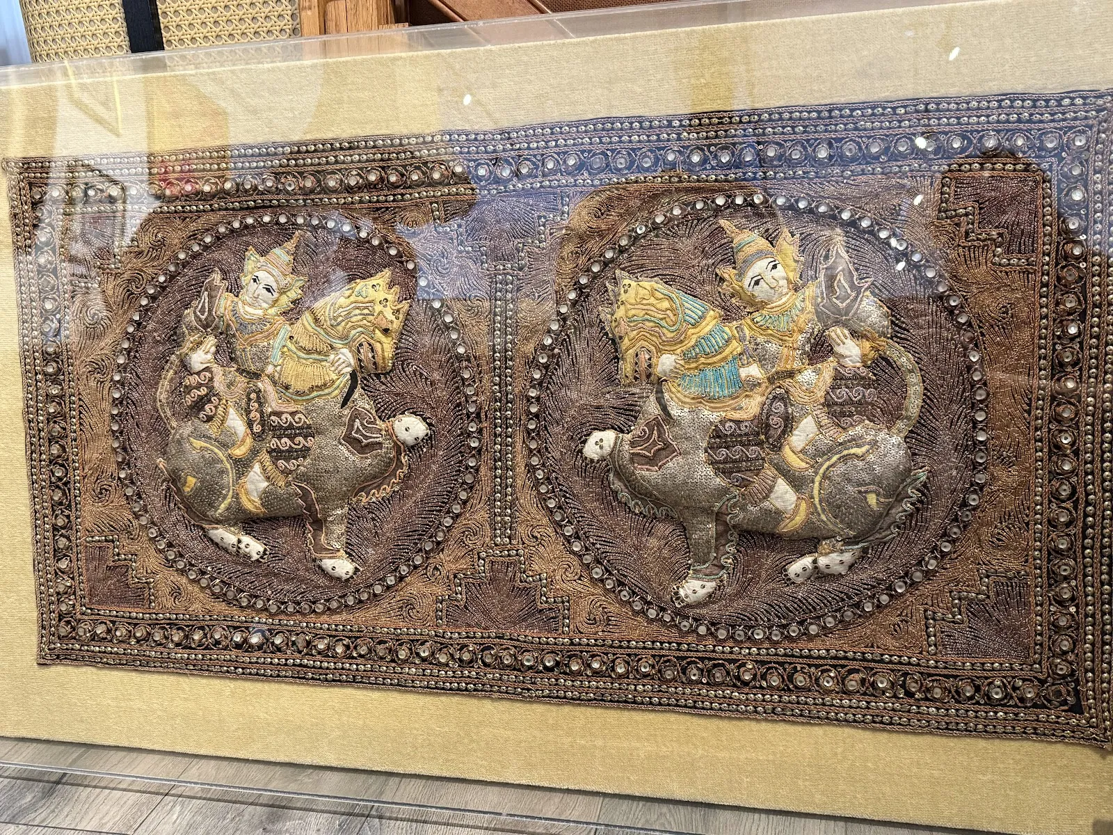 Carved wood panel with embossed medallion scenes