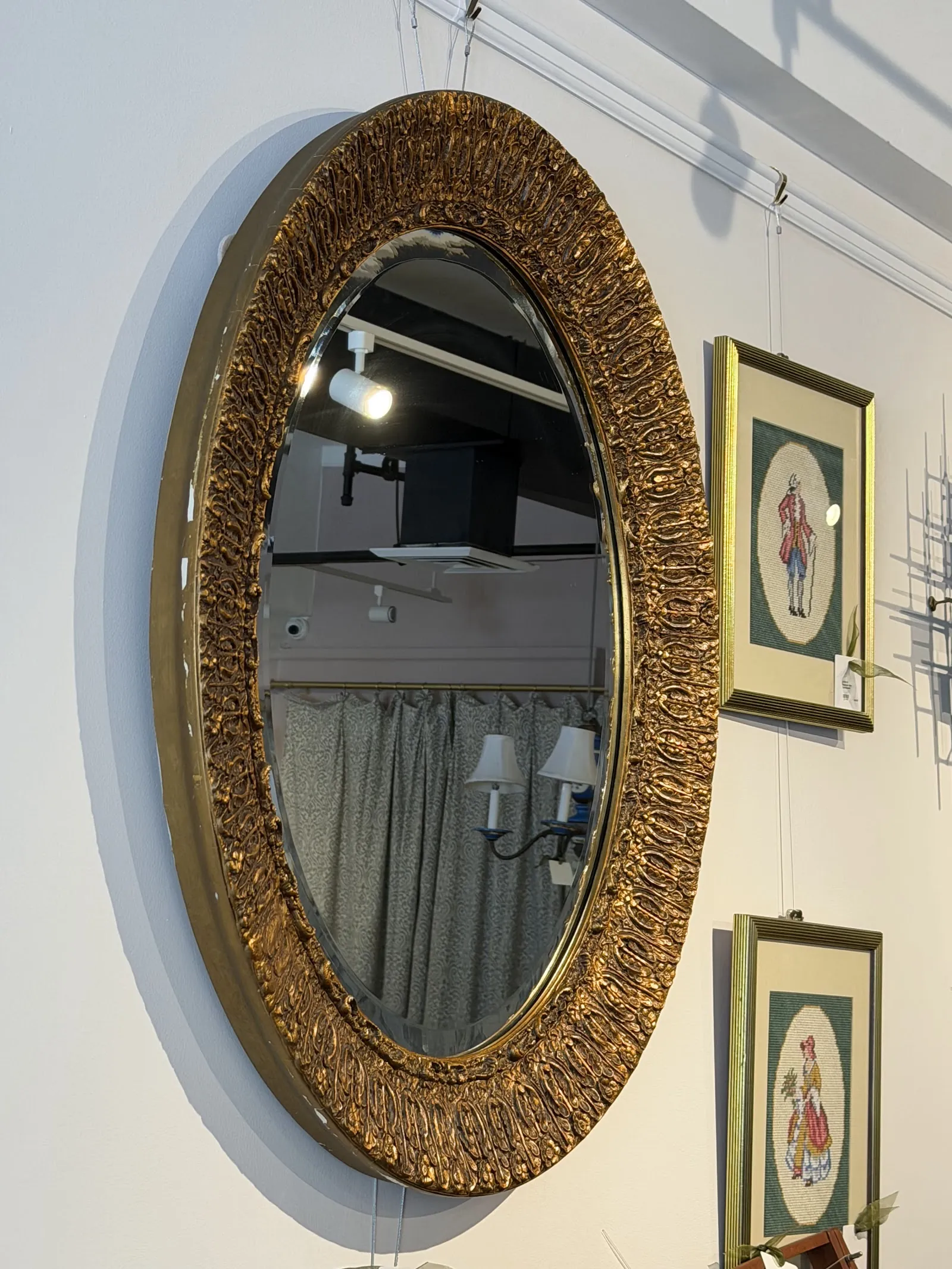 Oval mirror with ornate carved gold frame