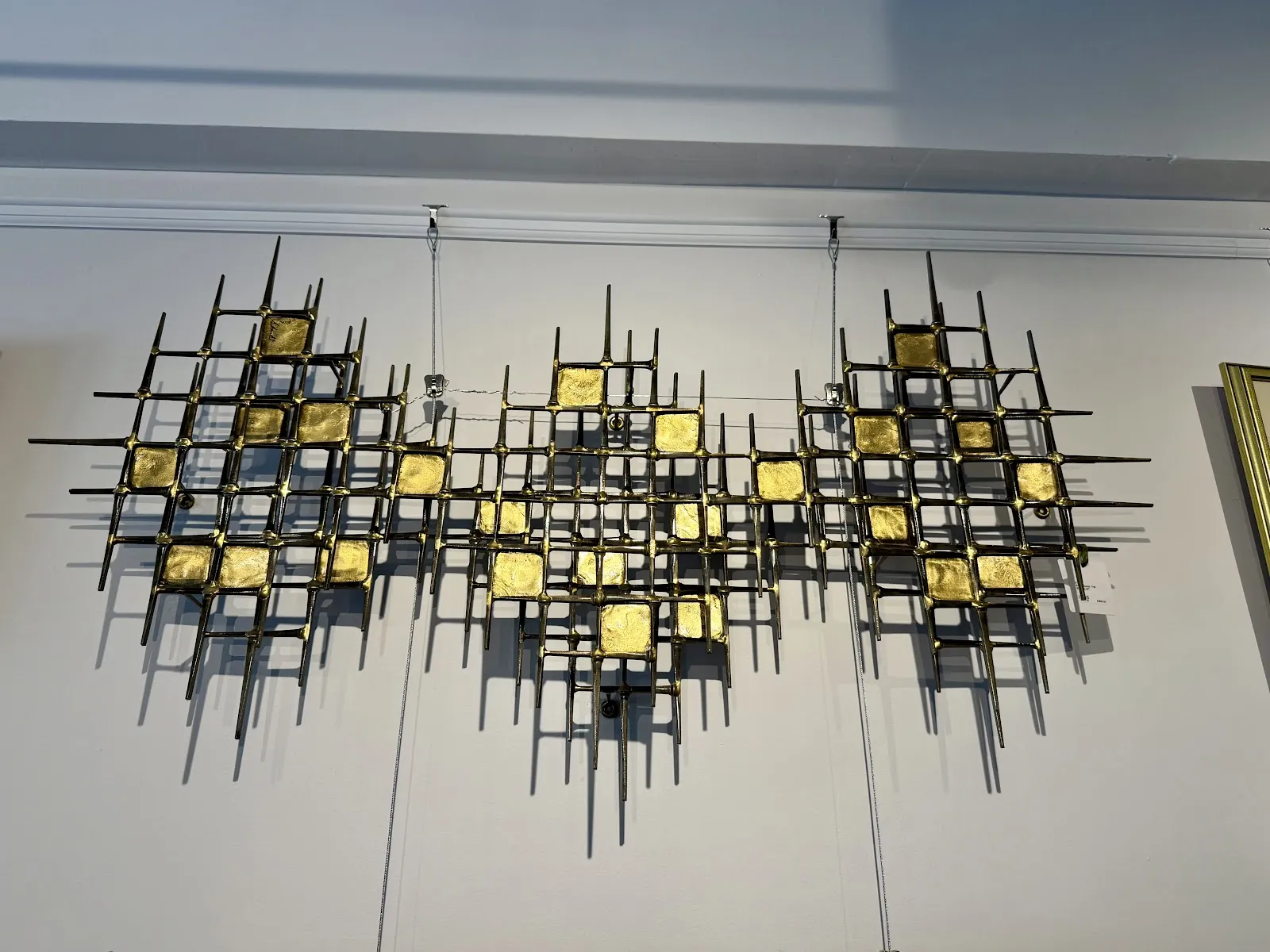 Mid-century metal wall sculpture with gold accents