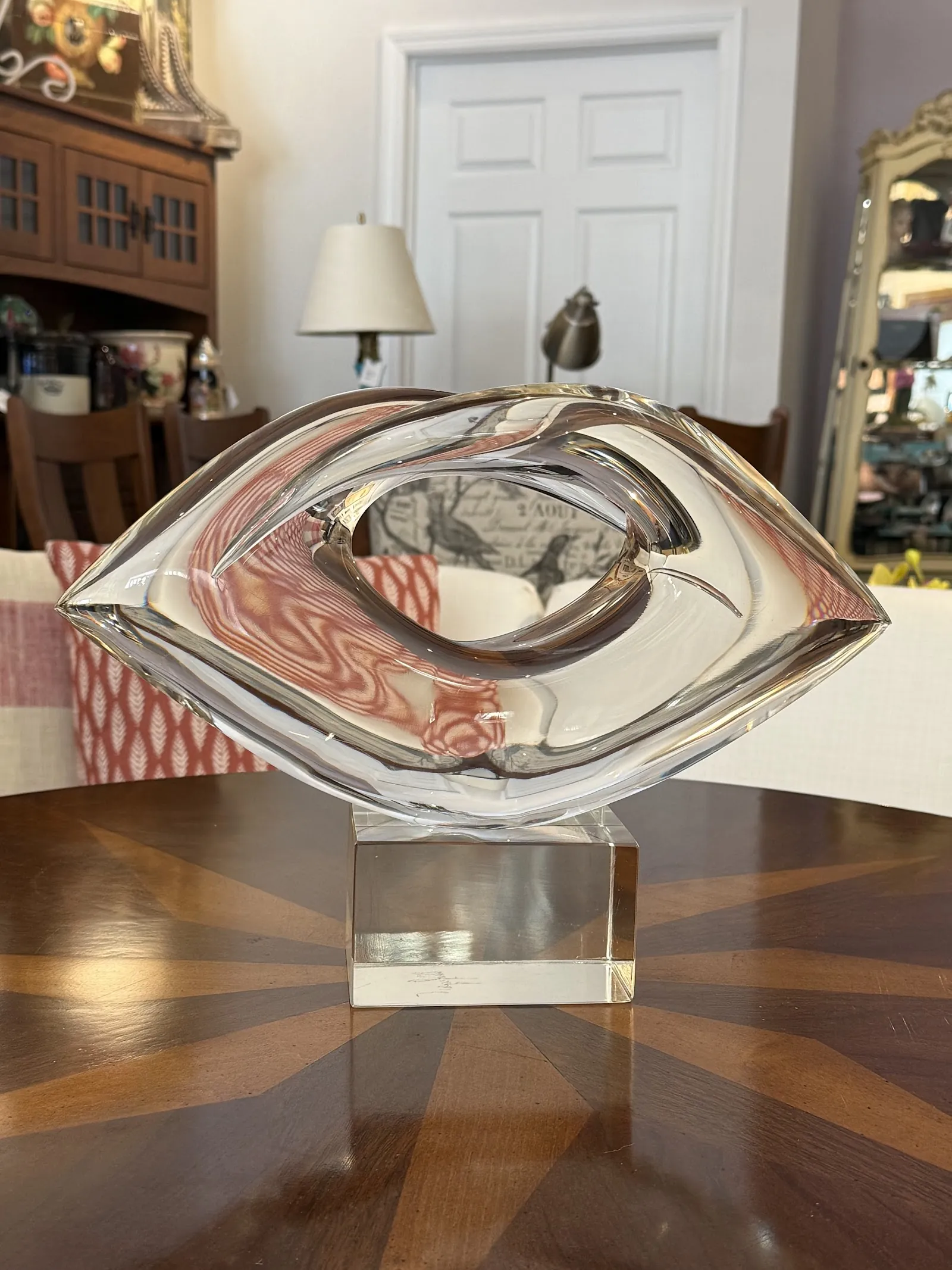 Decorative lips-and-eye pillow on a glass table