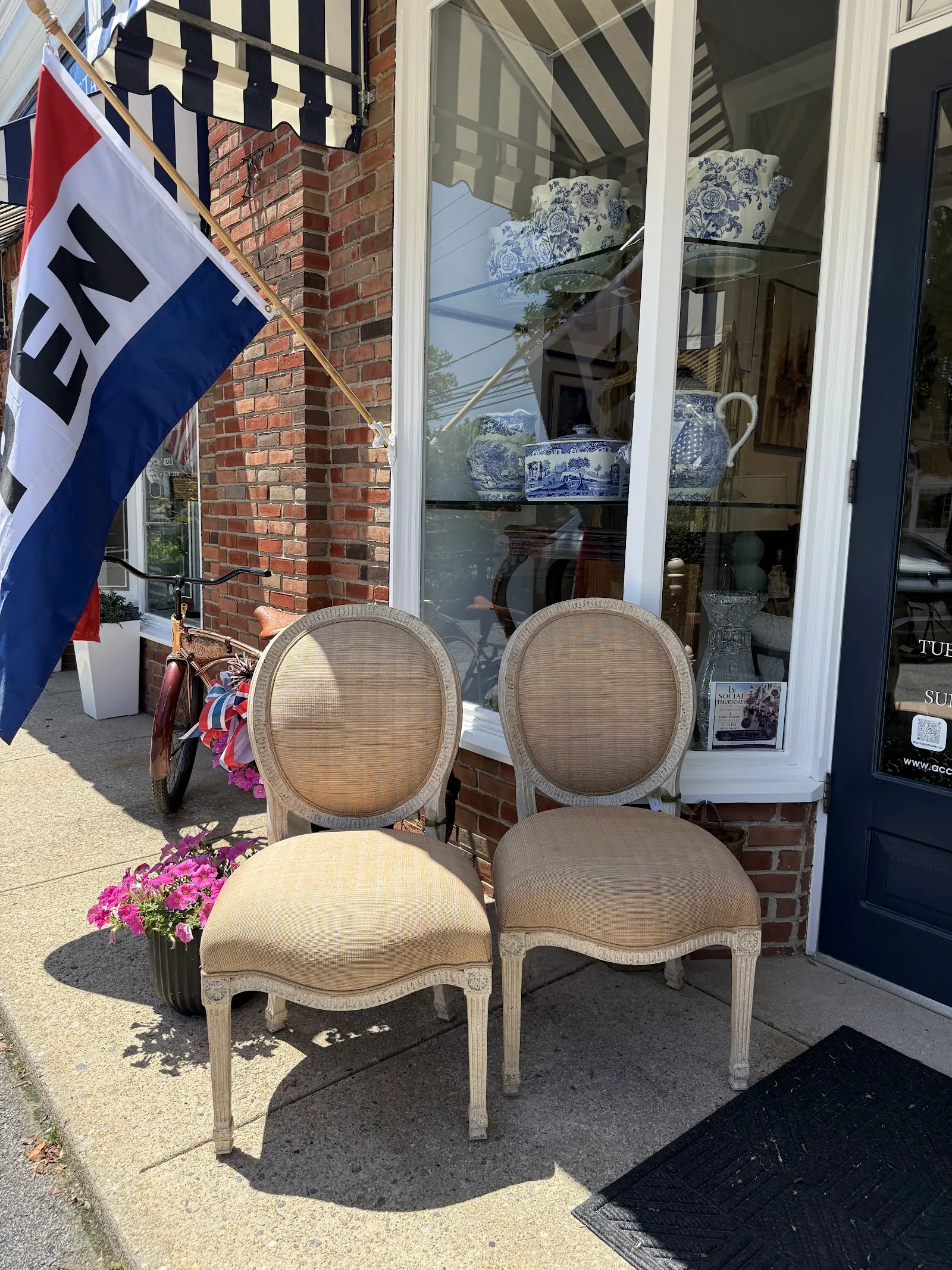 Accentiques storefront with flowers and chairs