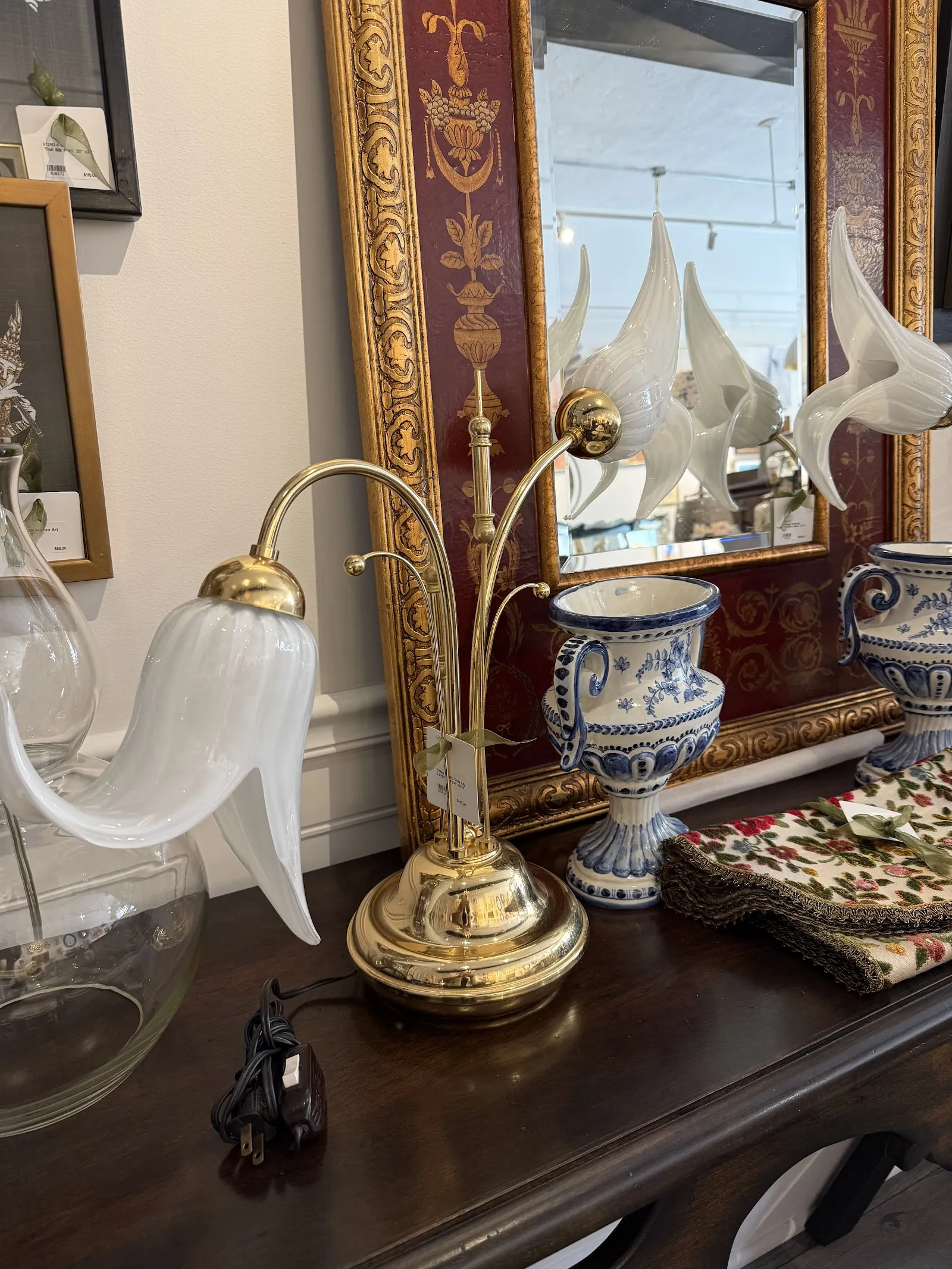 Brass table lamp on an ornate wood dresser