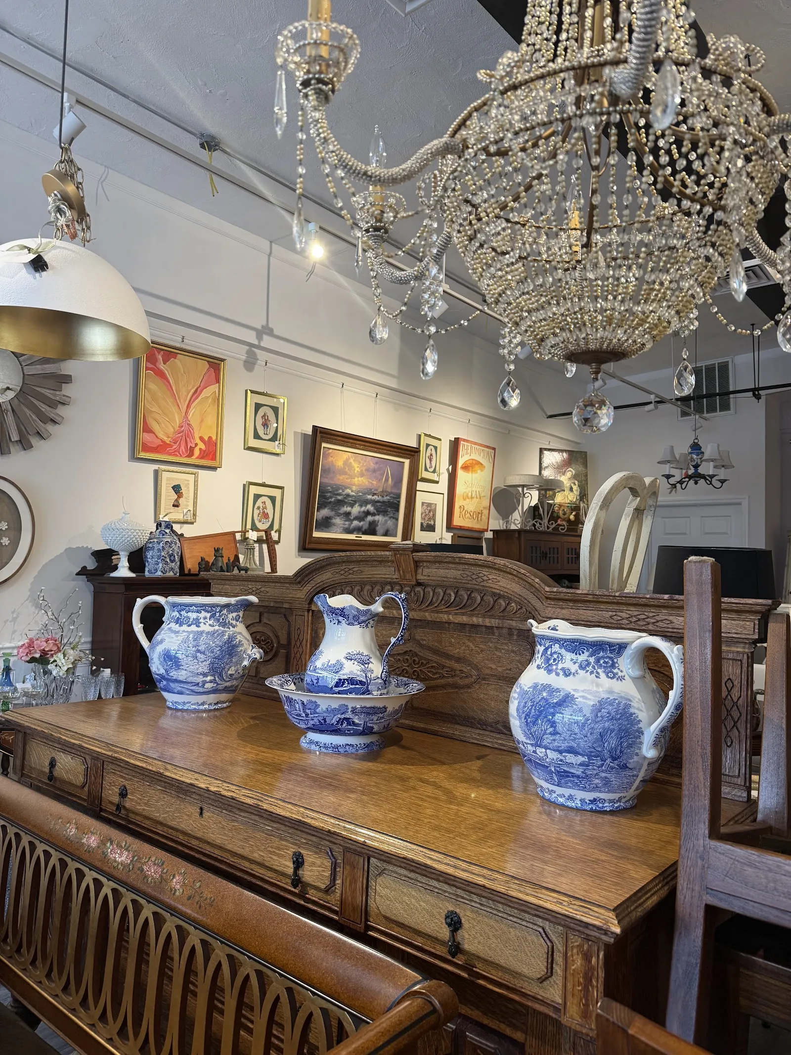 Shop interior with crystal chandelier and vintage pitchers